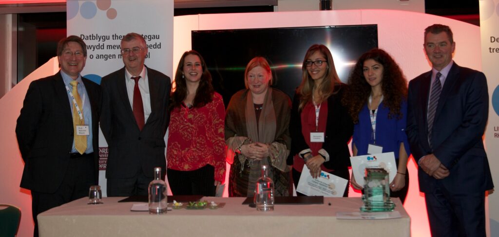 From left to right: Professor Malcolm Mason, Professor Mark Drakeford, Rachel Rowe, Mrs Edwina Hart OBE, Alessandra Cavaliere, Maria Konstantinou and Professor Chris McGuigan.